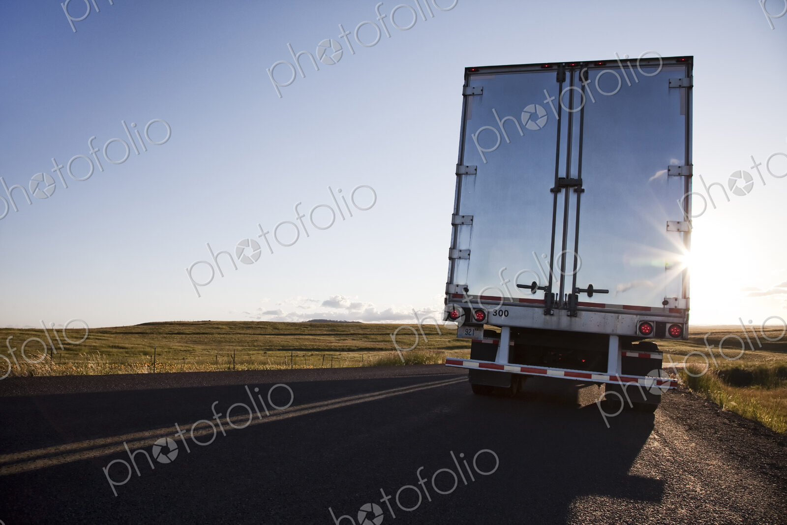 Rear view of the trailer on a Class 8 commercial truck on the highway.