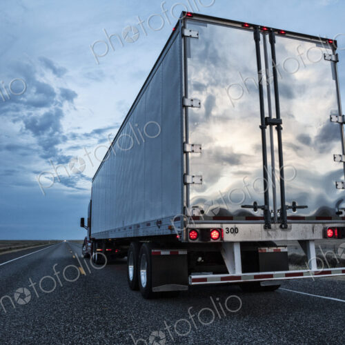 Rear view of the trailer on a Class 8 commercial truck on the highway.