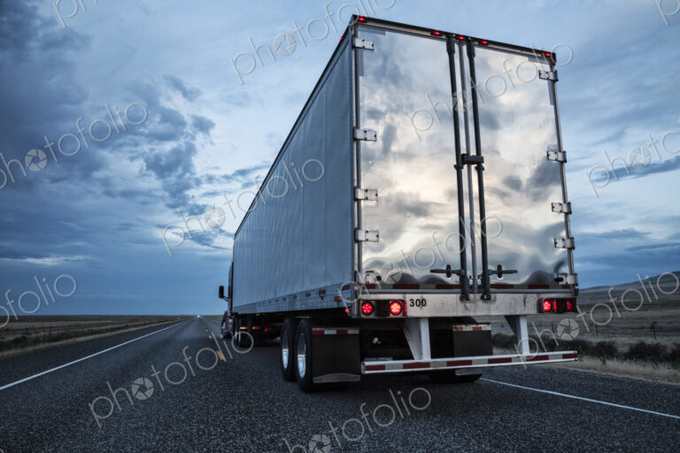 Rear view of the trailer on a Class 8 commercial truck on the highway.