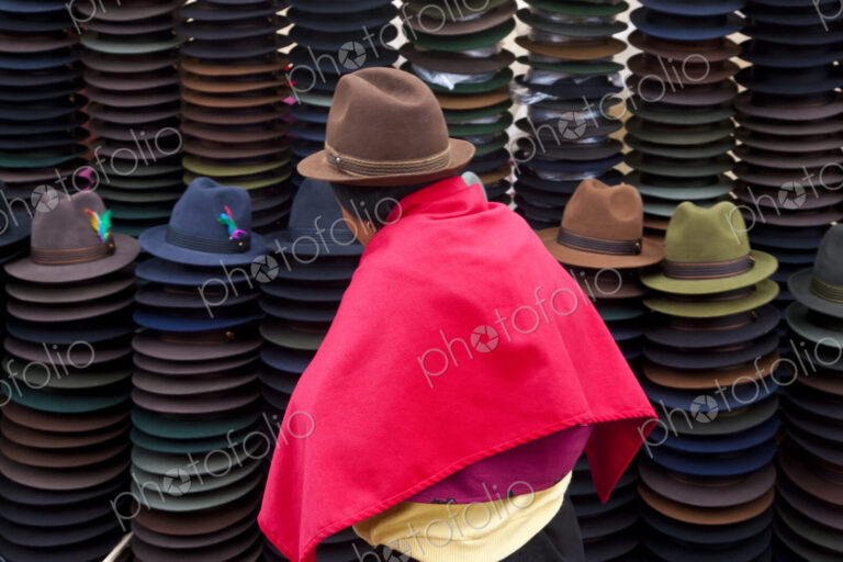 Rear view of woman selling traditional Ecuadorian felt hats.