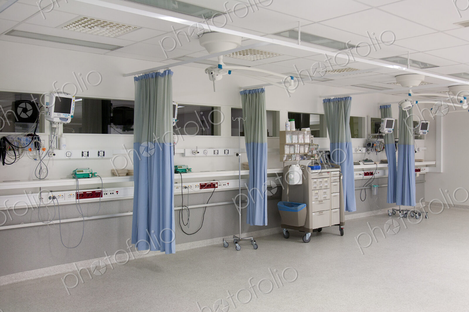 Recovery room in a modern hospital, post-operative recovery, patient bays with curtains