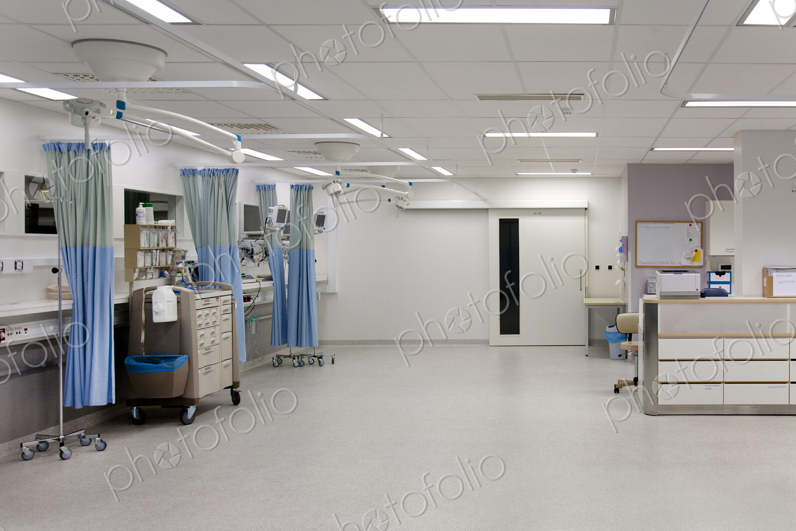Recovery room in a modern hospital, post-operative recovery, patient bays with curtains