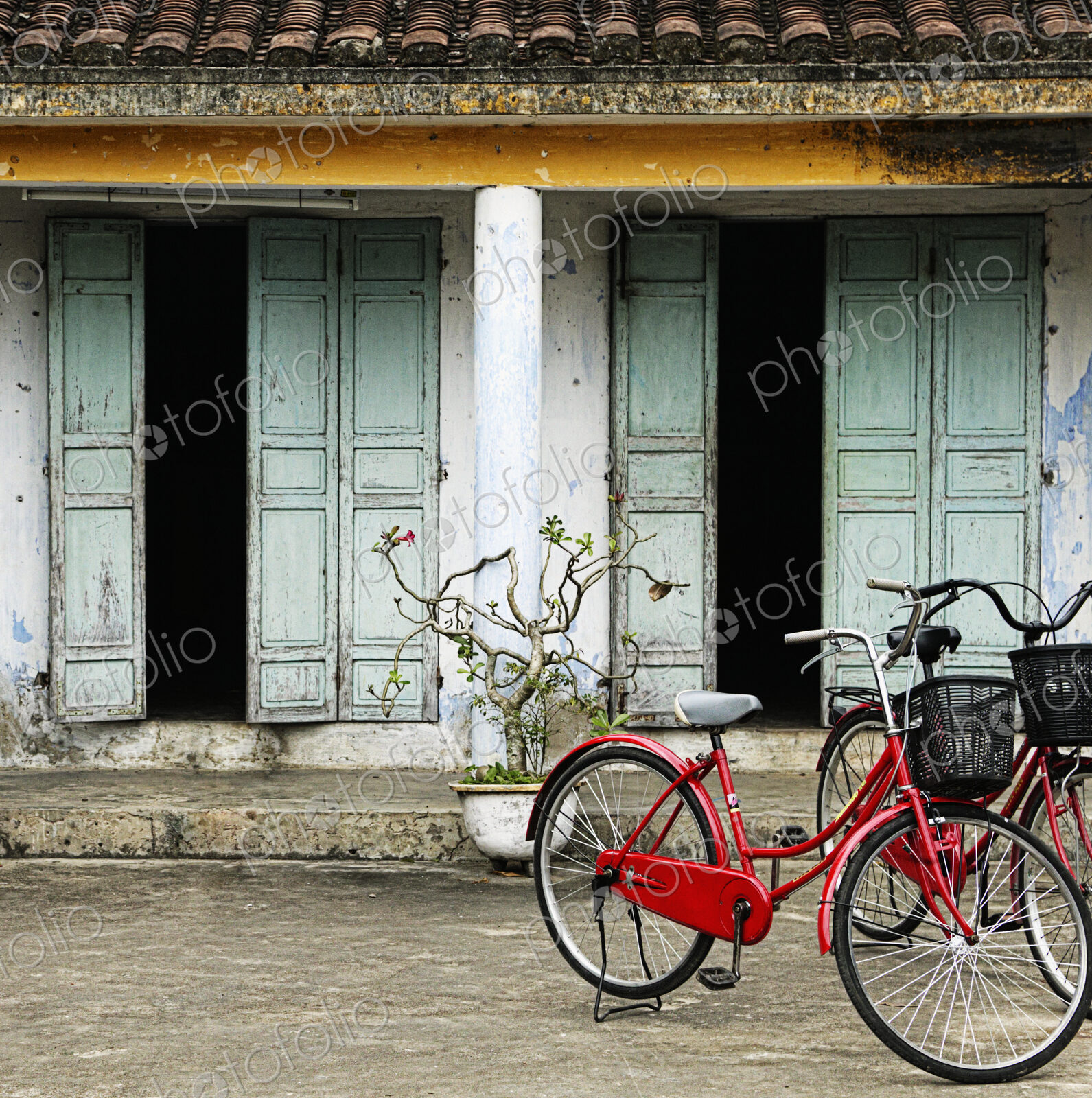 Red Bikes Parked in Front of a Weathered Building