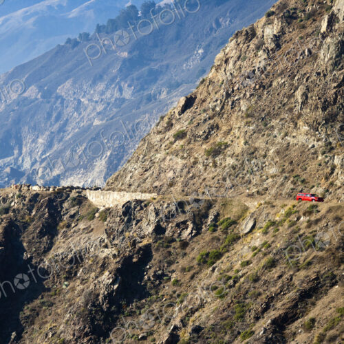 Red Car on Coastal Mountain Road Red Car on Coastal Mountain Road