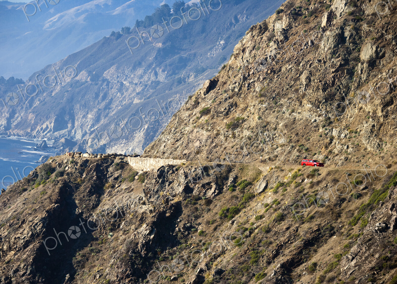 Red Car on Coastal Mountain Road