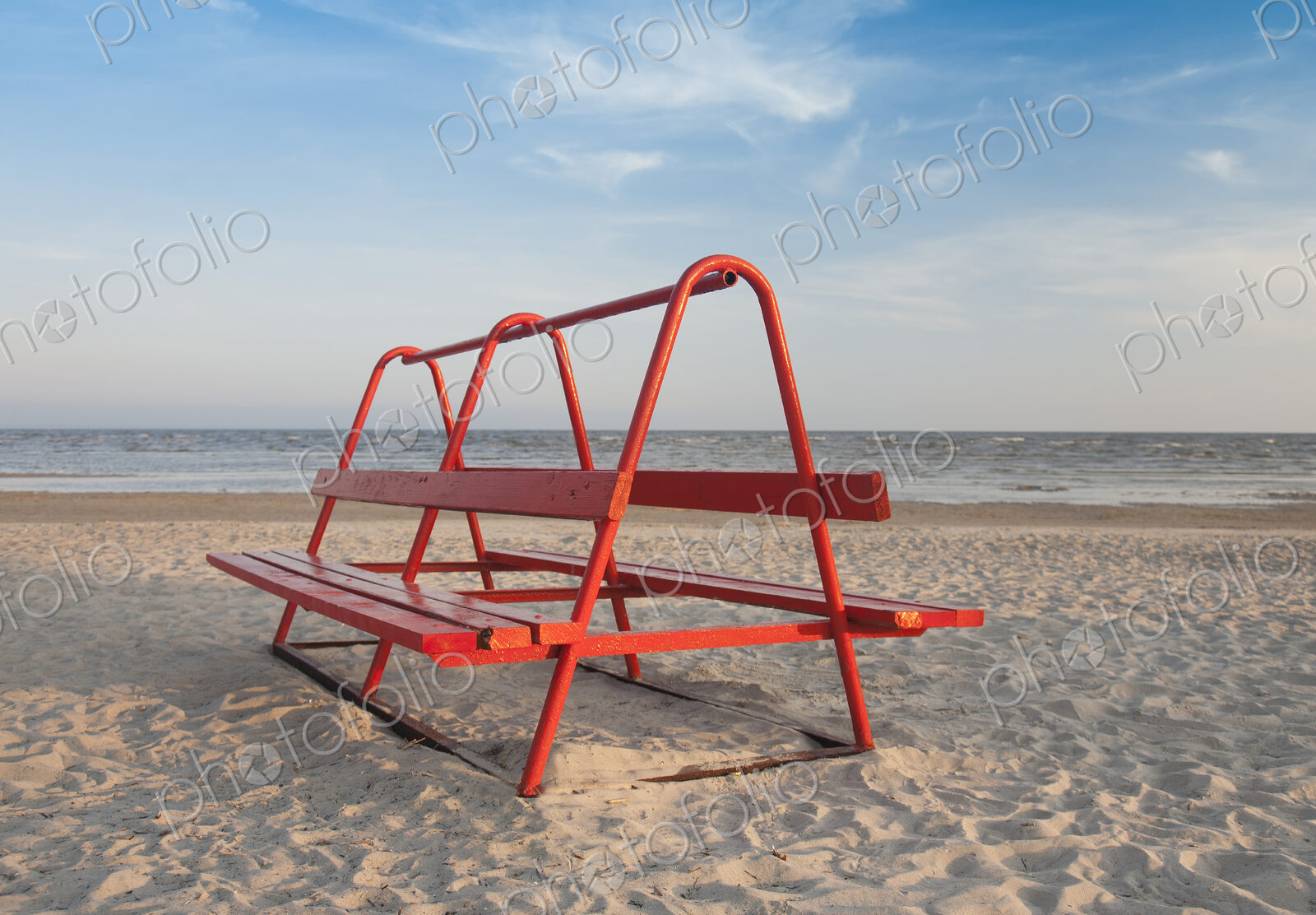 Red Park Bench on the Beach