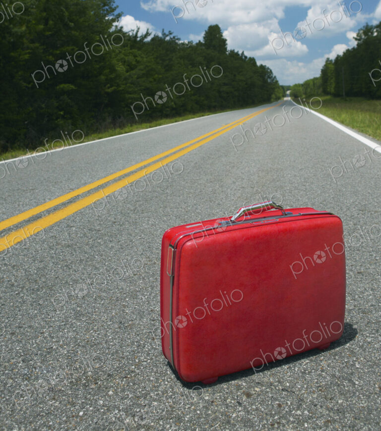 Red Suitcase Abandoned in Road