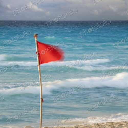 Red flag on tropical beach in hotel zone, Cancun, Yucatan Peninsula, Quintana Roo, Mexico Red flag on tropical beach in hotel zone, Cancun, Yucatan Peninsula, Quintana Roo, Mexico