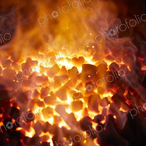Red-hot glowing coals in a furnace.