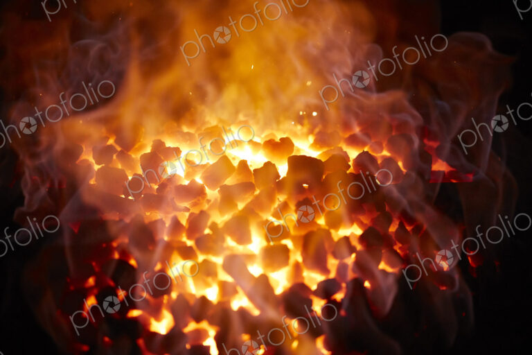 Red-hot glowing coals in a furnace.