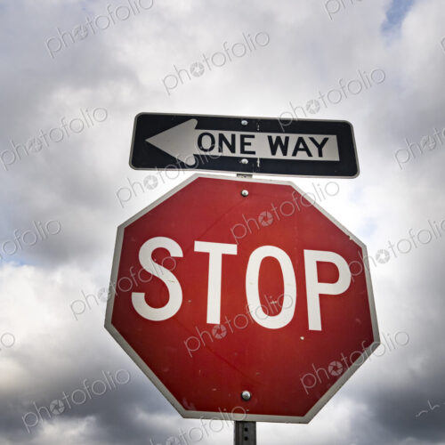 Red stop sign with One Way sign attached Red stop sign with One Way sign attached