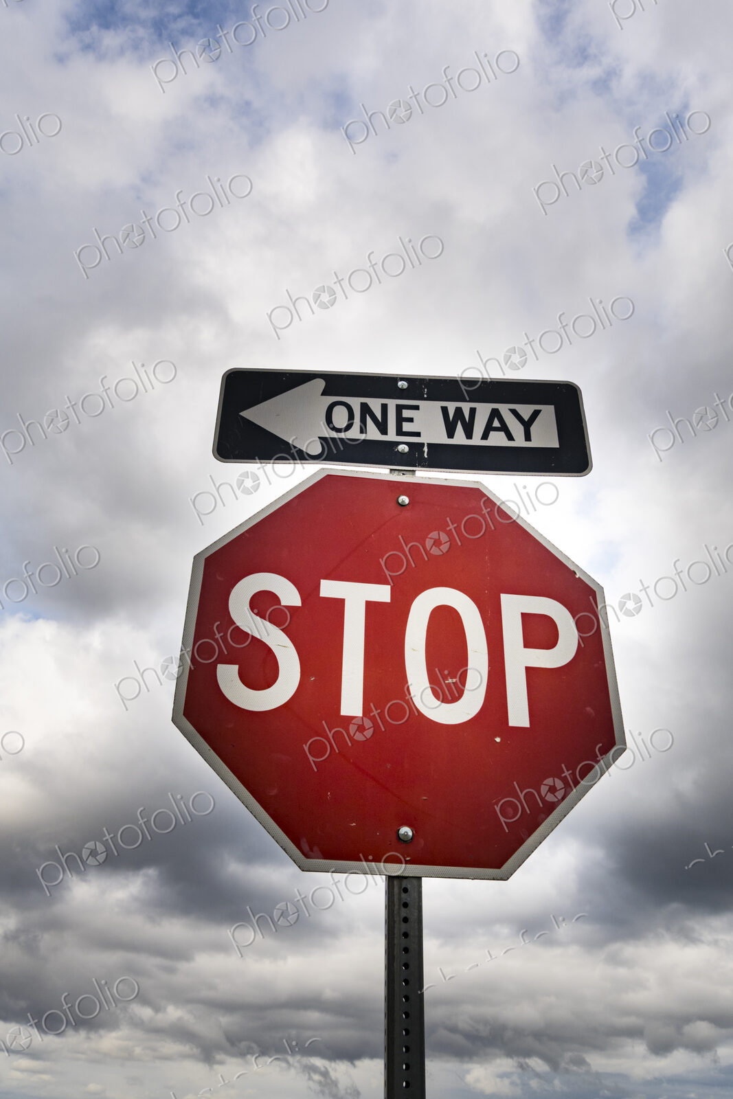 Red stop sign with One Way sign attached