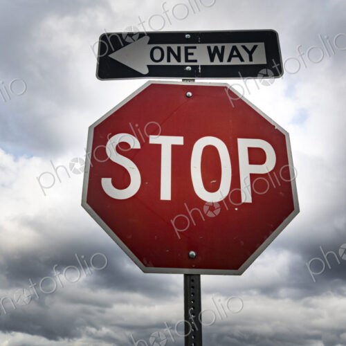 Red stop sign with One Way sign attached Red stop sign with One Way sign attached