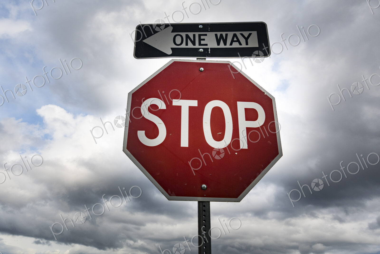 Red stop sign with One Way sign attached