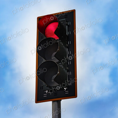 Red stoplight on a pole, a low angle view