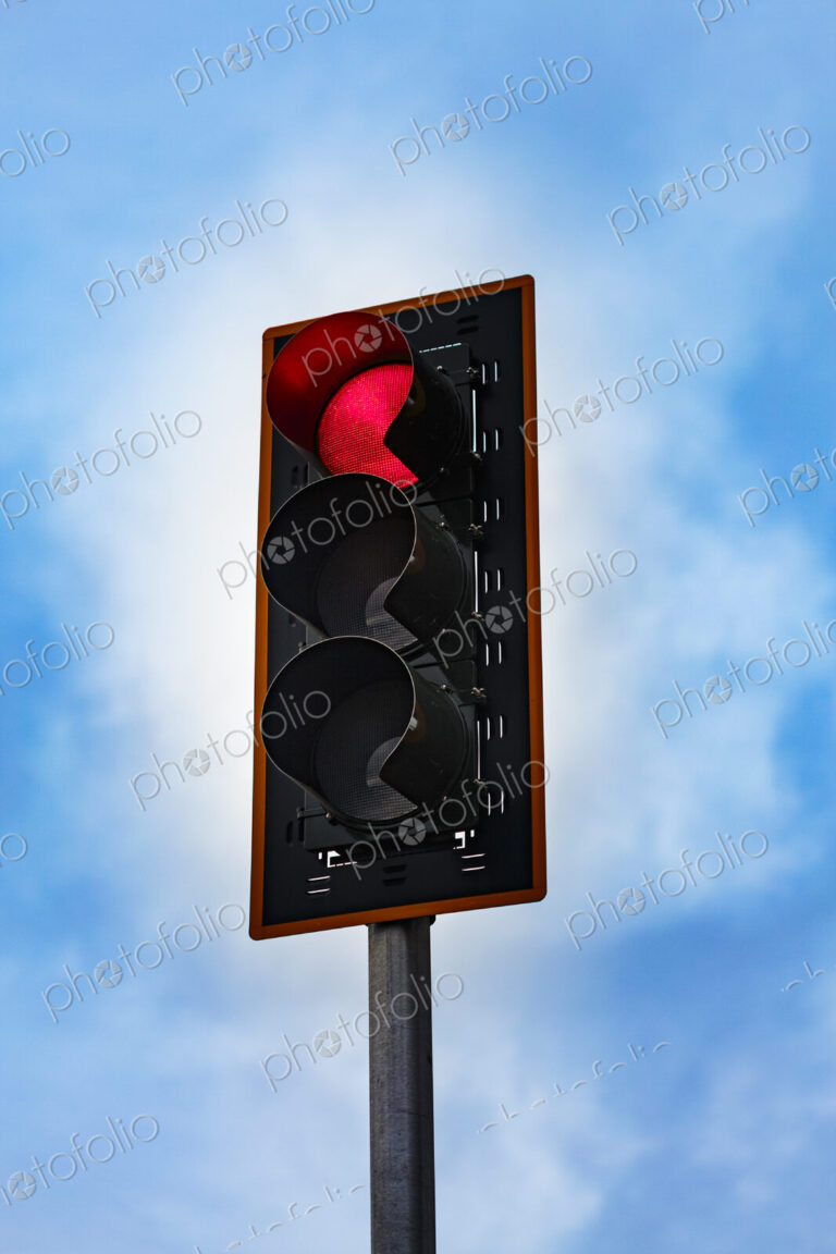Red stoplight on a pole, a low angle view