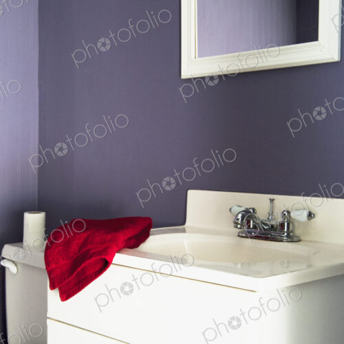 Red towel on sink in modern bathroom Red towel on sink in modern bathroom