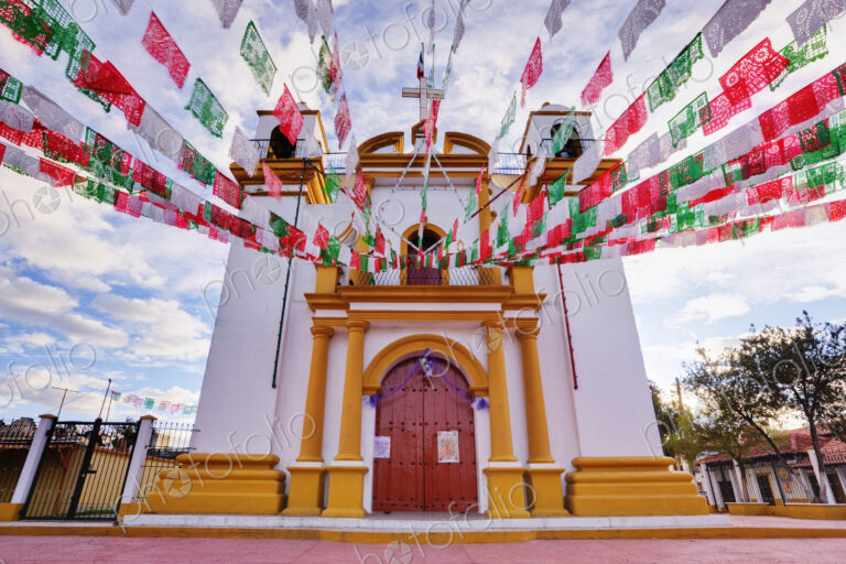 Red, white and green banners on church, Chiapas, Mexico