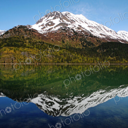 Reflection of mountain in still lake Reflection of mountain in still lake