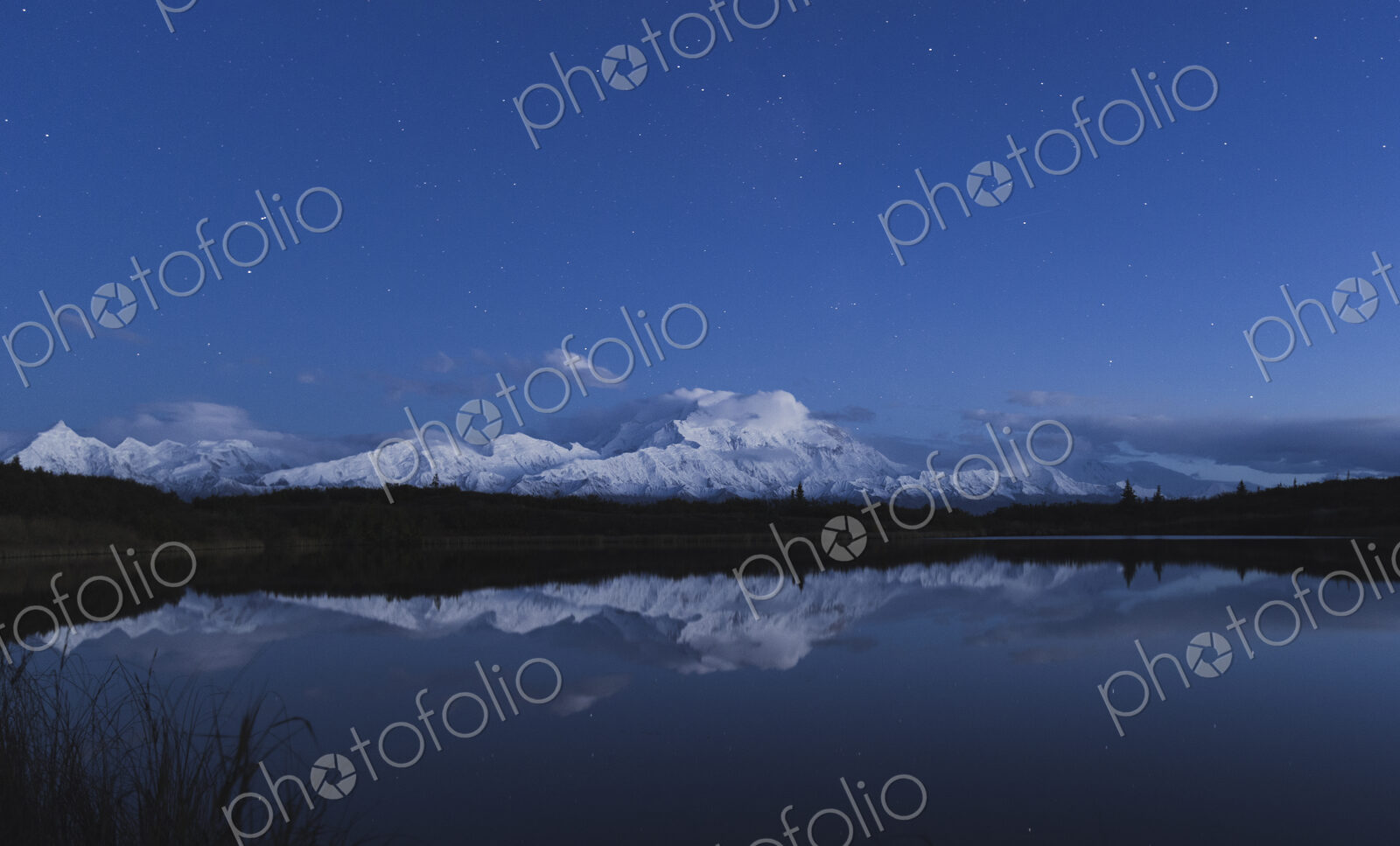 Reflection of scenic view of mountain in pond