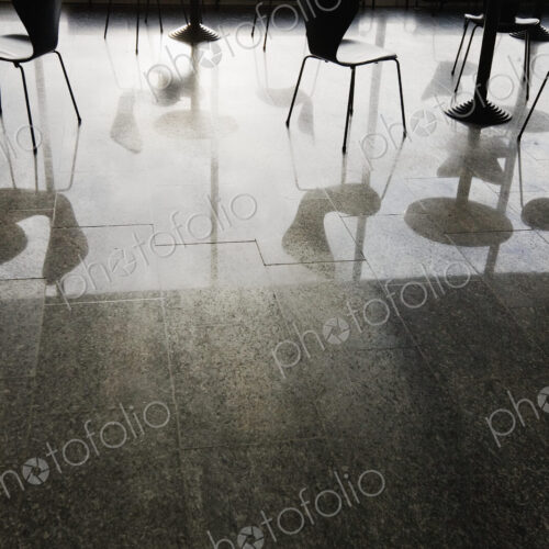 Reflections of Tables and Chairs on Shiny Floor Reflections of Tables and Chairs on Shiny Floor