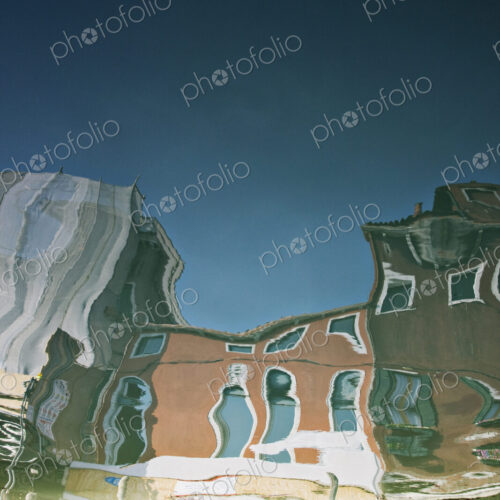 Reflections of buildings in canal water. Reflections of buildings in canal water.