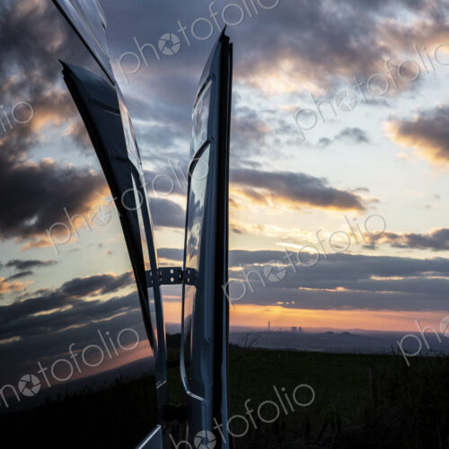 Reflections of clouds on camper van window at sunset. Reflections of clouds on camper van window at sunset.