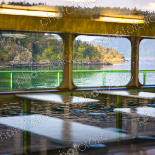 Reflections on the roof and interior of a ferry from the shore and the water. Reflections on the roof and interior of a ferry from the shore and the water.