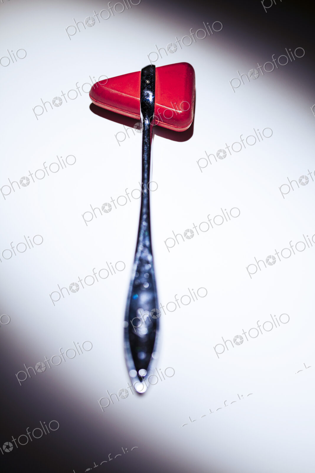 Reflex hammer, a medical tool, white background, studio shot.