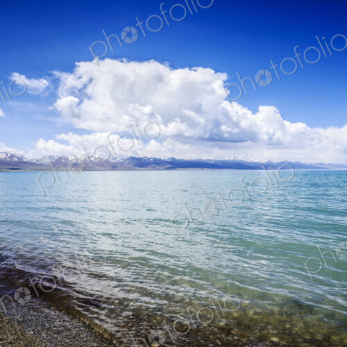 Remote lake and shore with blue sky