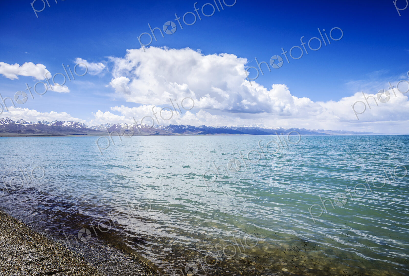 Remote lake and shore with blue sky