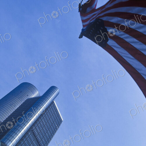 Renaissance Center, tall buildings, low angle view and American flag flying. Renaissance Center, tall buildings, low angle view and American flag flying.