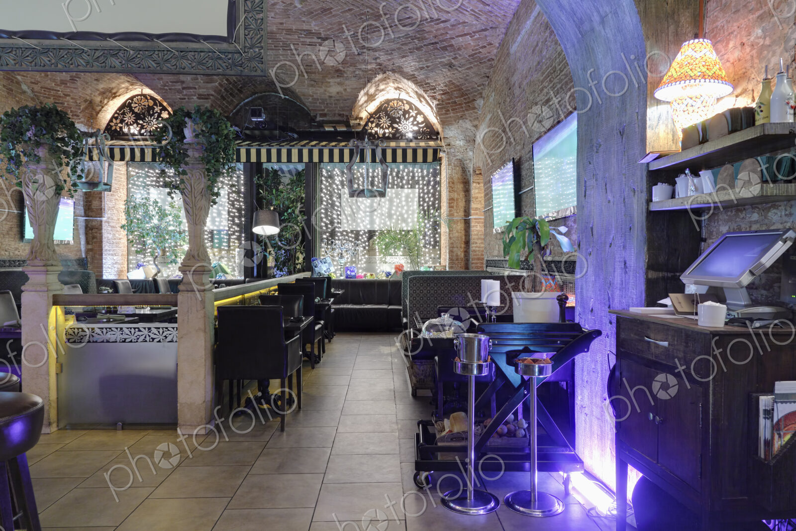 Restaurant interior illuminated with purple lights.