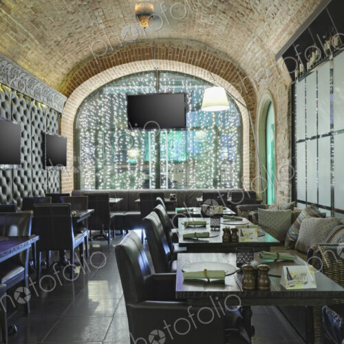 Restaurant interior with one wall made of glass and other of leather. Restaurant interior with one wall made of glass and other of leather.