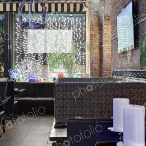 Restaurant windows decorated with gift boxes and illumination.