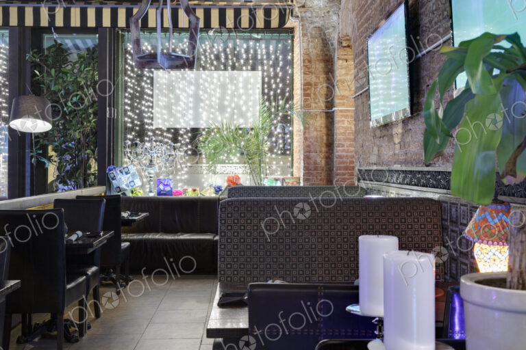 Restaurant windows decorated with gift boxes and illumination.