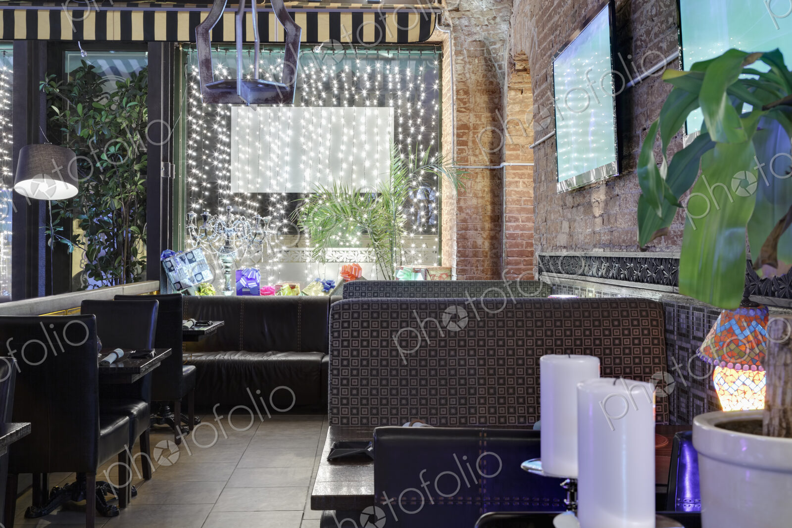 Restaurant windows decorated with gift boxes and illumination.