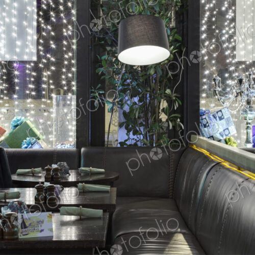 Restaurant windows decorated with gift boxes and illumination.