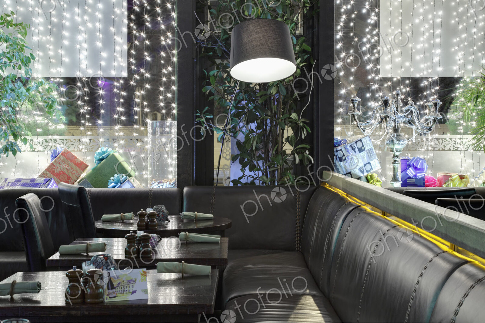 Restaurant windows decorated with gift boxes and illumination.