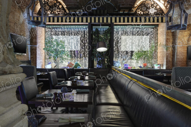 Restaurant with windows decorated with gift boxes and illumination.