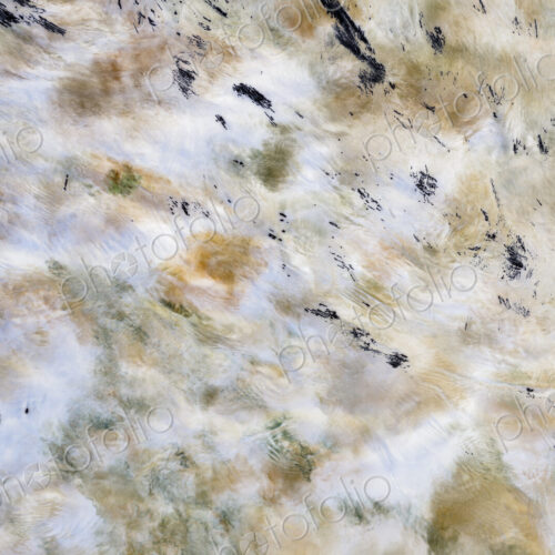River water abstract, long exposure of river water flowing over boulders and rocks