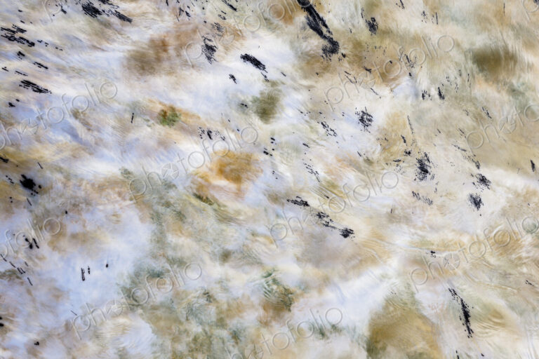 River water abstract, long exposure of river water flowing over boulders and rocks