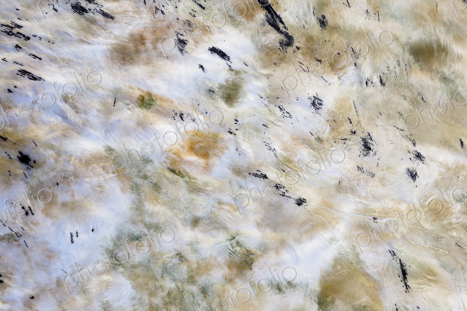 River water abstract, long exposure of river water flowing over boulders and rocks