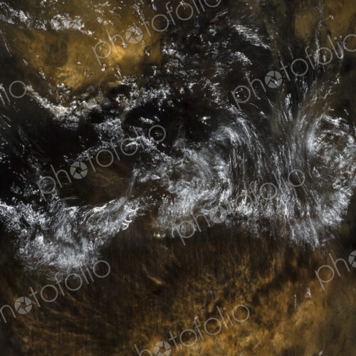 River water abstract, long exposure of river water flowing over boulders and rocks River water abstract, long exposure of river water flowing over boulders and rocks