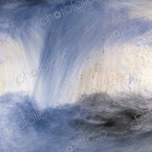 River water abstract, long exposure of river water flowing over boulders and rocks
