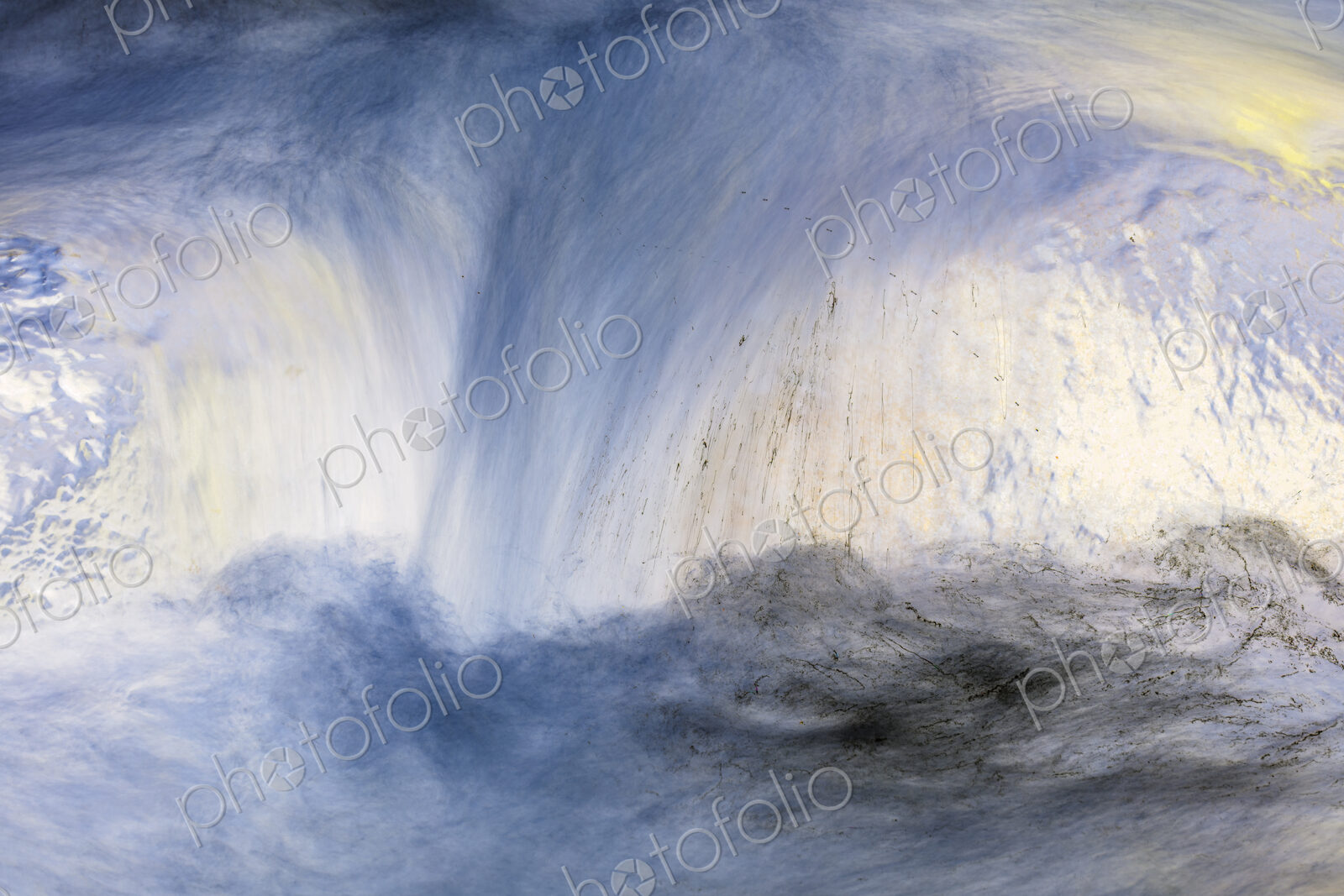 River water abstract, long exposure of river water flowing over boulders and rocks
