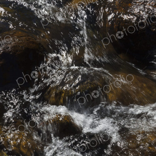 River water abstract, long exposure of river water flowing over boulders and rocks River water abstract, long exposure of river water flowing over boulders and rocks