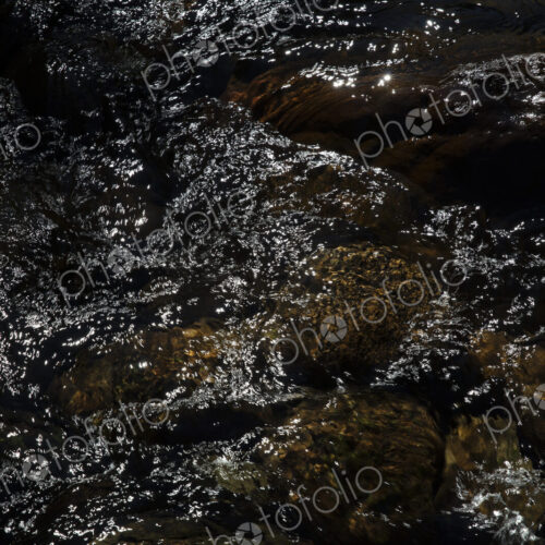 River water abstract, long exposure of river water flowing over boulders and rocks River water abstract, long exposure of river water flowing over boulders and rocks