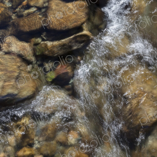 River water abstract, long exposure of river water flowing over boulders and rocks River water abstract, long exposure of river water flowing over boulders and rocks
