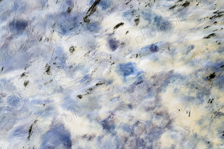 River water abstract, long exposure of river water flowing over boulders and rocks,…